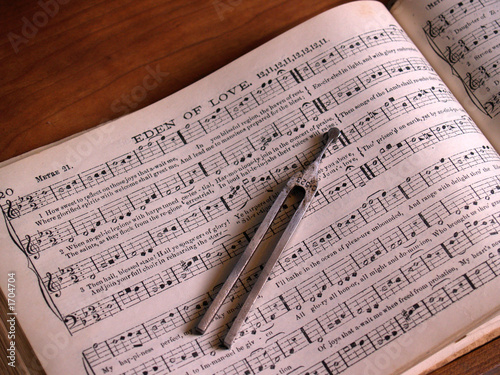 shaped note hymnal with song leader's tuning fork photo
