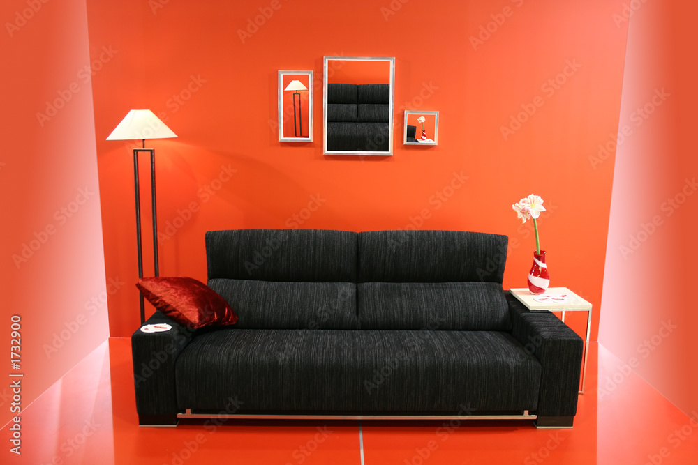 black sofa on red wall Stock Photo | Adobe Stock