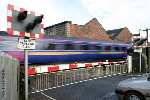 Valokuva train going through level crossing