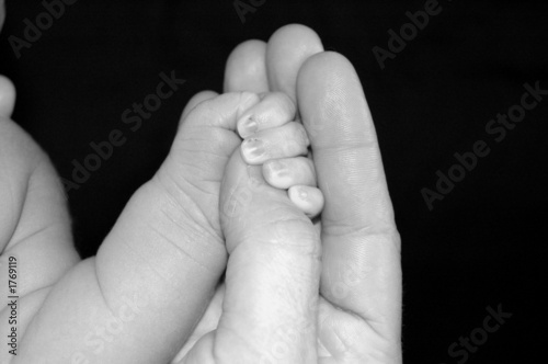 newborn/adult hands