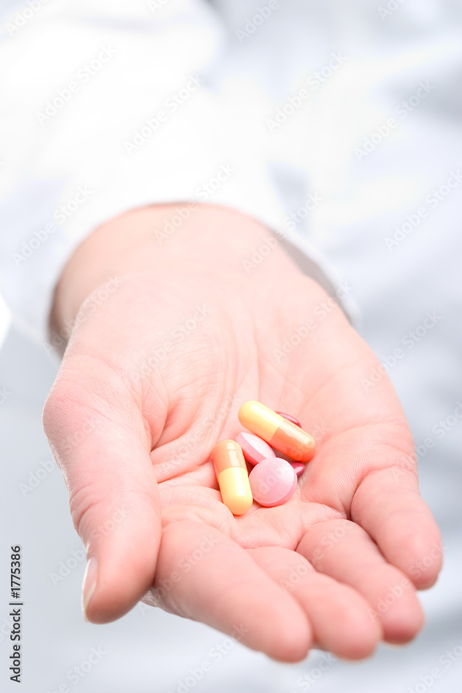 woman holding pills woman holding pills