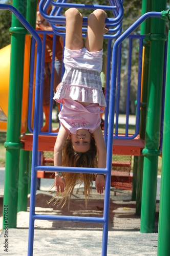 upside-down girl on monkey bars