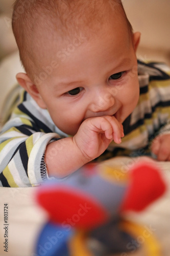 baby boy reaching for a toy