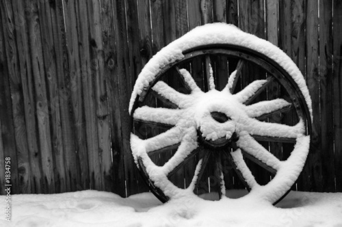 antique wagon wheel with snow