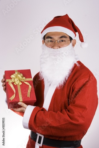 santa claus holding a present © Shirley
