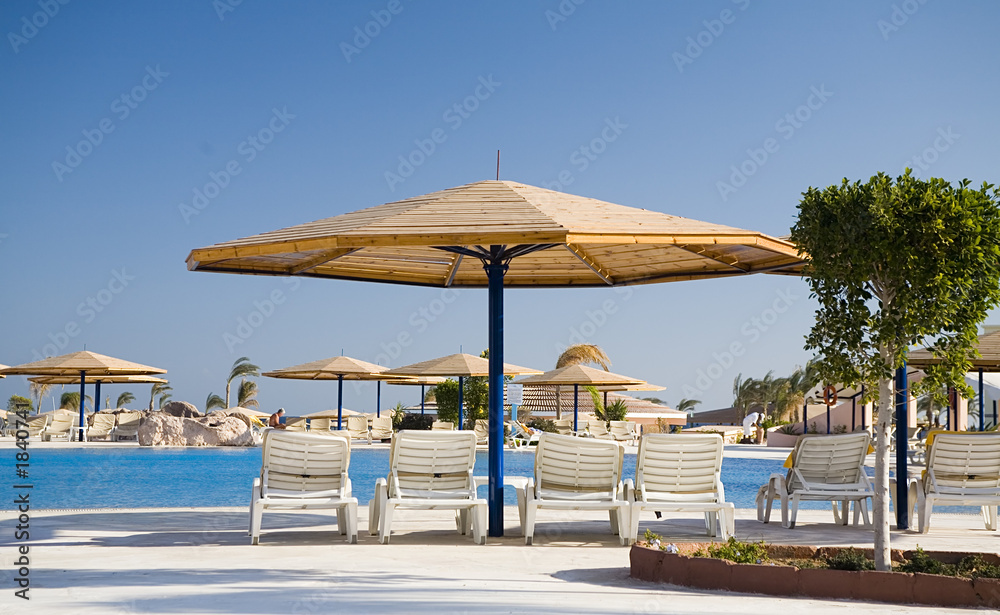 parasol and chaise-longue in hotel