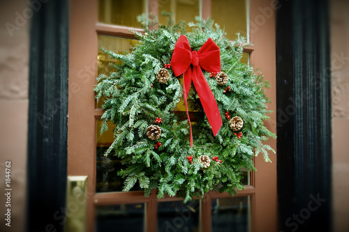 antiqued christmas wreath hanging on door
