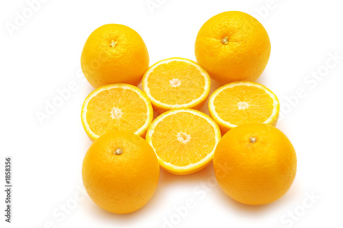 whole and cut oranges isolated on white