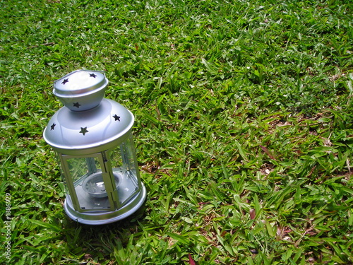 silver christmas lamp on green grass background