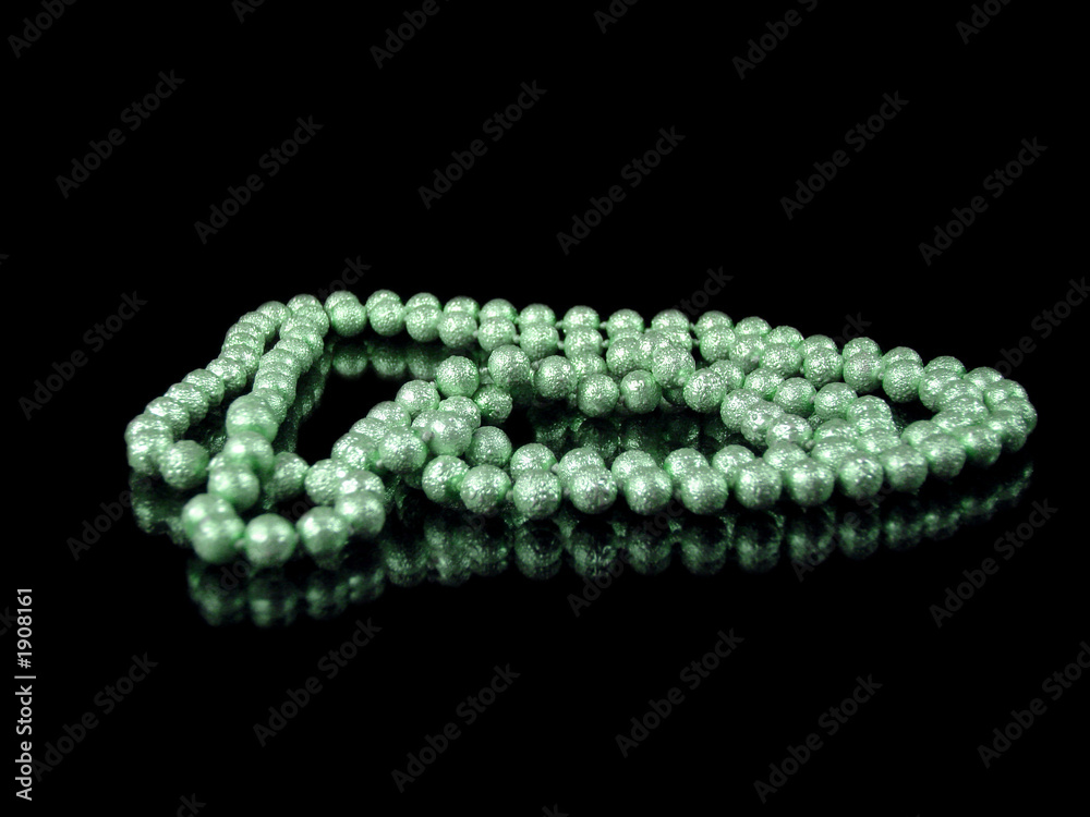 string of green pearls isolated on black with reflection string of green pearls isolated on black with reflection