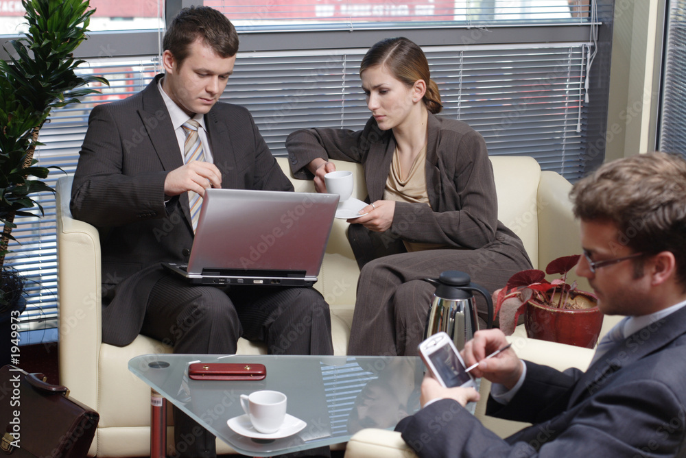 Fototapeta premium men and woman in an office - working with latop an