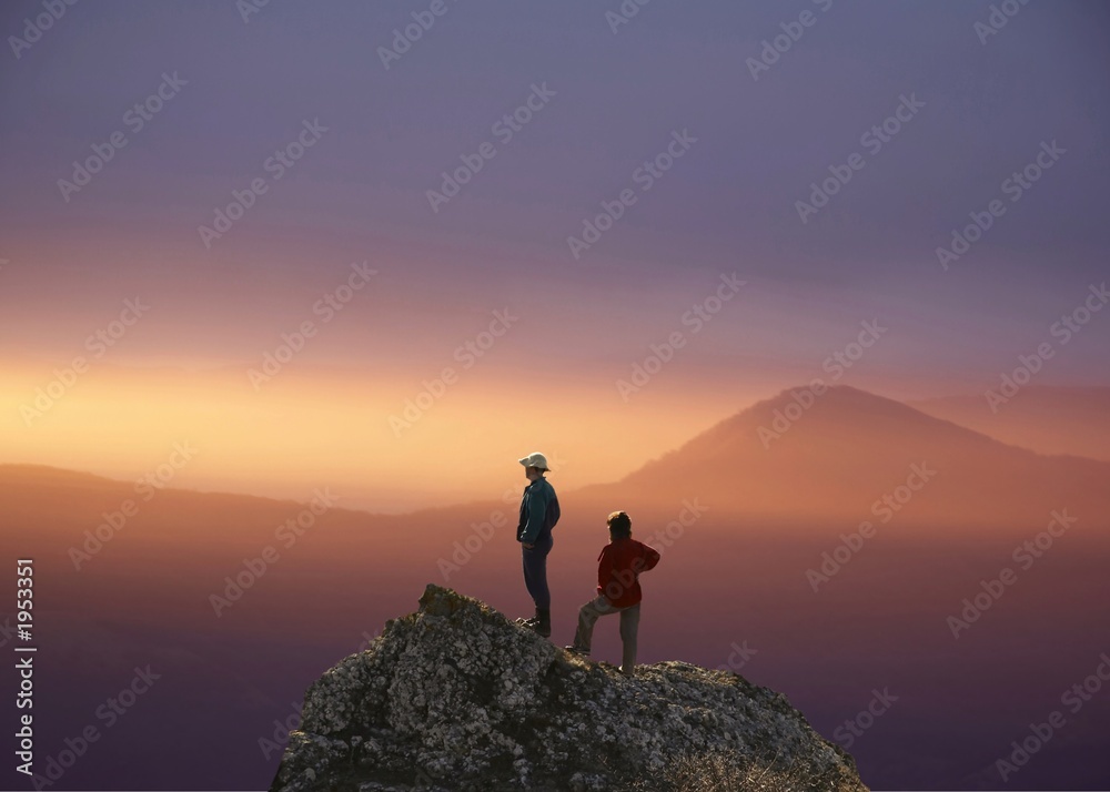 people on the rock on sunset