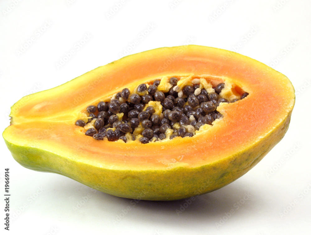 papaya sliced in half on white papaya sliced in half on white