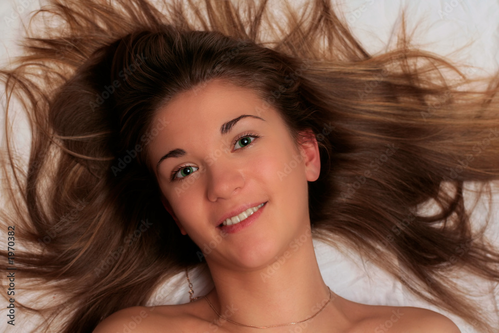 beautiful girl with green eyes lying on bedheet beautiful girl with green eyes lying on bedheet
