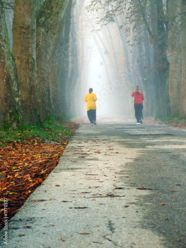 couple jogging in logn alley photo