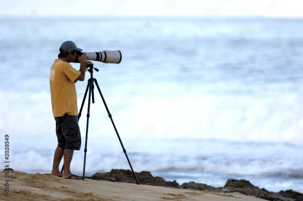 man taking photo on beach