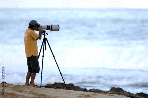man taking photo on beach © NorthShoreSurfPhotos
