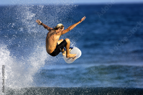 surfer doing an ariel © NorthShoreSurfPhotos
