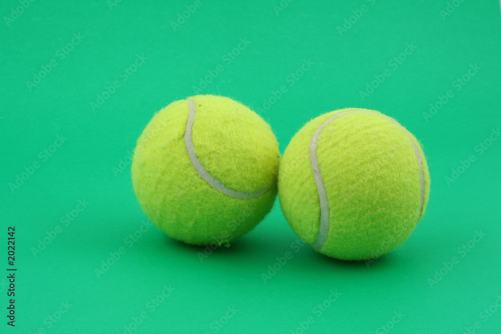 two tennis balls on green