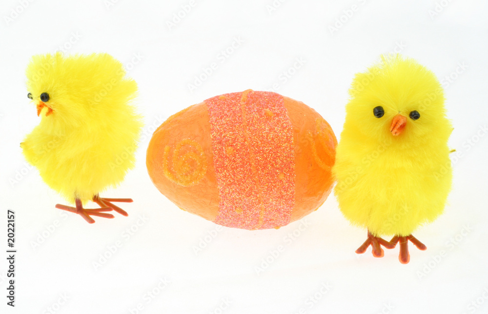 two toy chickens with decorated easter egg