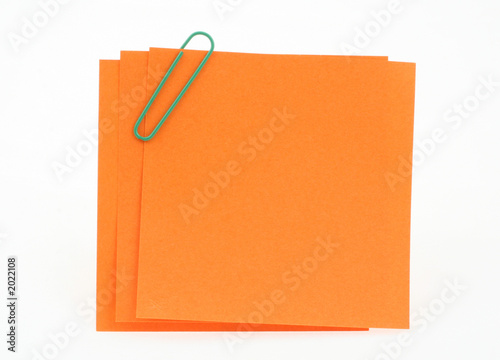 three post-it notes with green paperclip