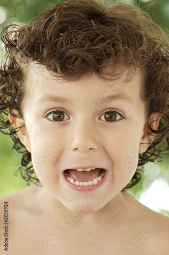 adorable happy boy making trivialities photo