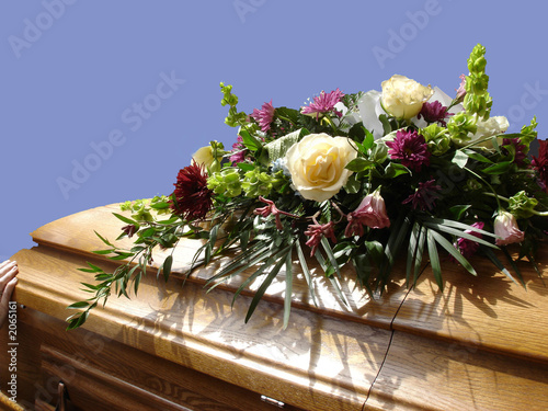 casket with flowers, blue sky photo