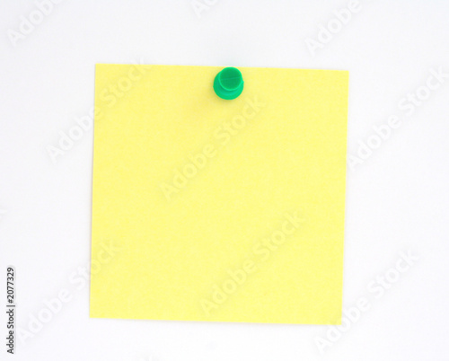 post-it note pinned to white paper wall