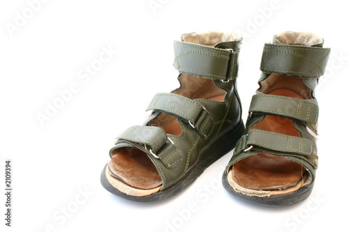 used children's orthopaedic sandals on white backg photo