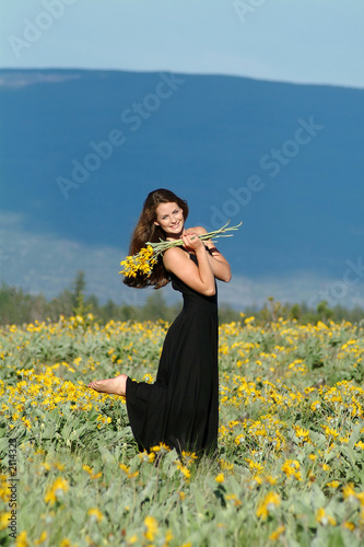 woman in field of flowers photo