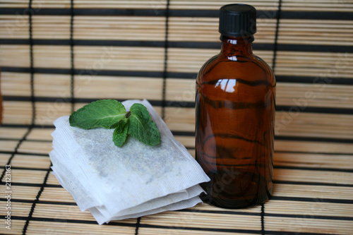 bottle with tea bags and mint leaf