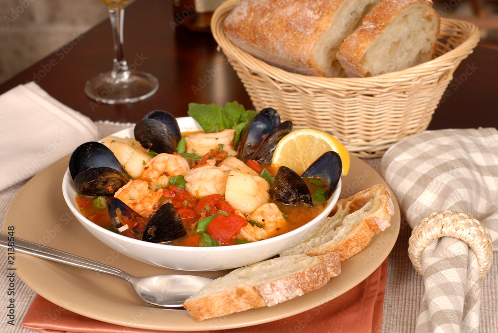 bowl of delicious seafood soup with wine and rustic bread bowl of delicious seafood soup with wine and rustic bread