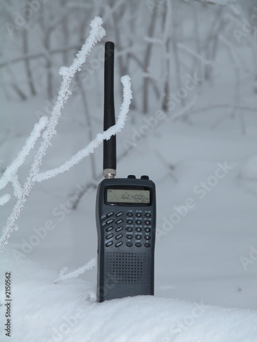 weather radio in a cold winter forest covered in ice and snow photo