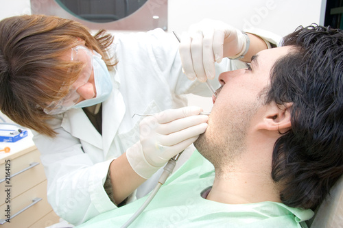 female dentist examining a patient