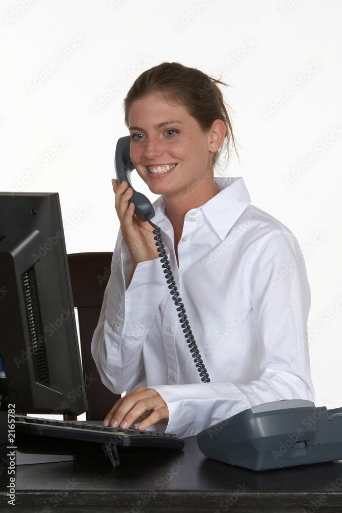 young woman at desk talking on phone young woman at desk talking on phone