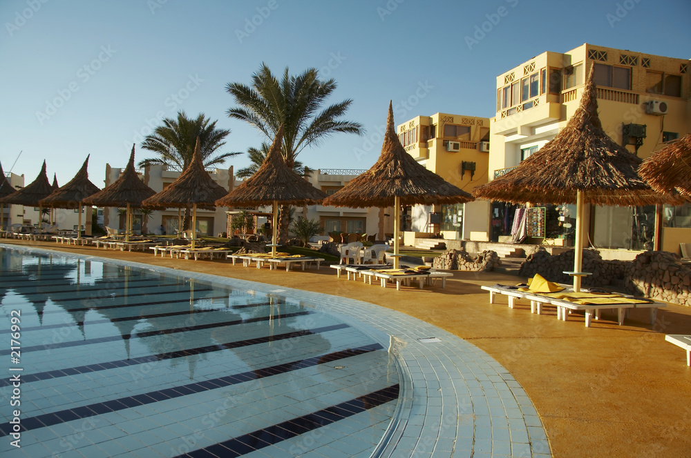 swimming-pool and parasols group on resort swimming-pool and parasols group on resort