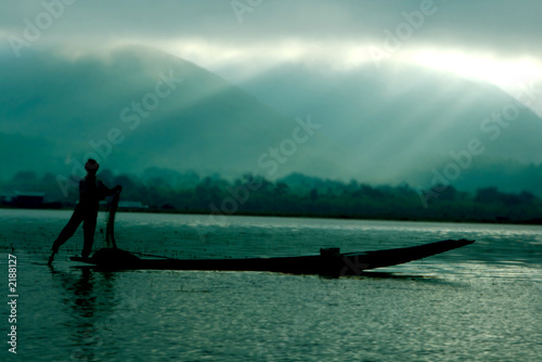 silhouette of fisherman in boat