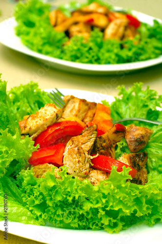 hot chicken salad with lettuce, apples and tomatoe
