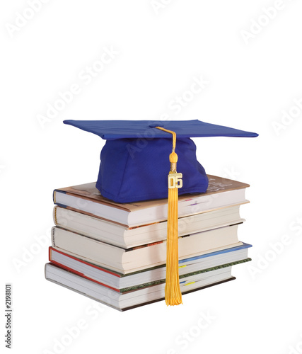 graduation cap on books