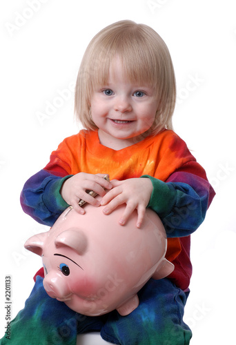 toddler holding a piggy bank
