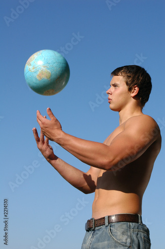 young muscular man playing with a terrestrial globe © Vladimir Wrangel