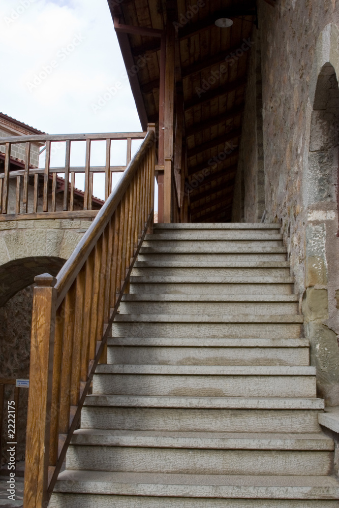 stone staircase with wooden railing