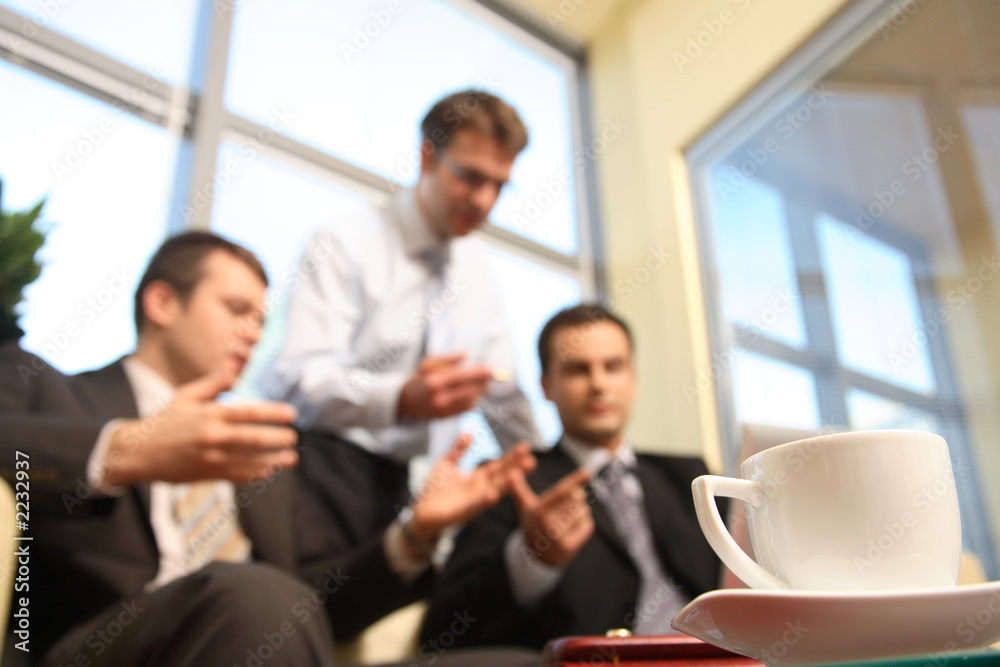 young business men talking in an office - blur