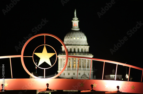 star of texas with the state capitol building at night photo