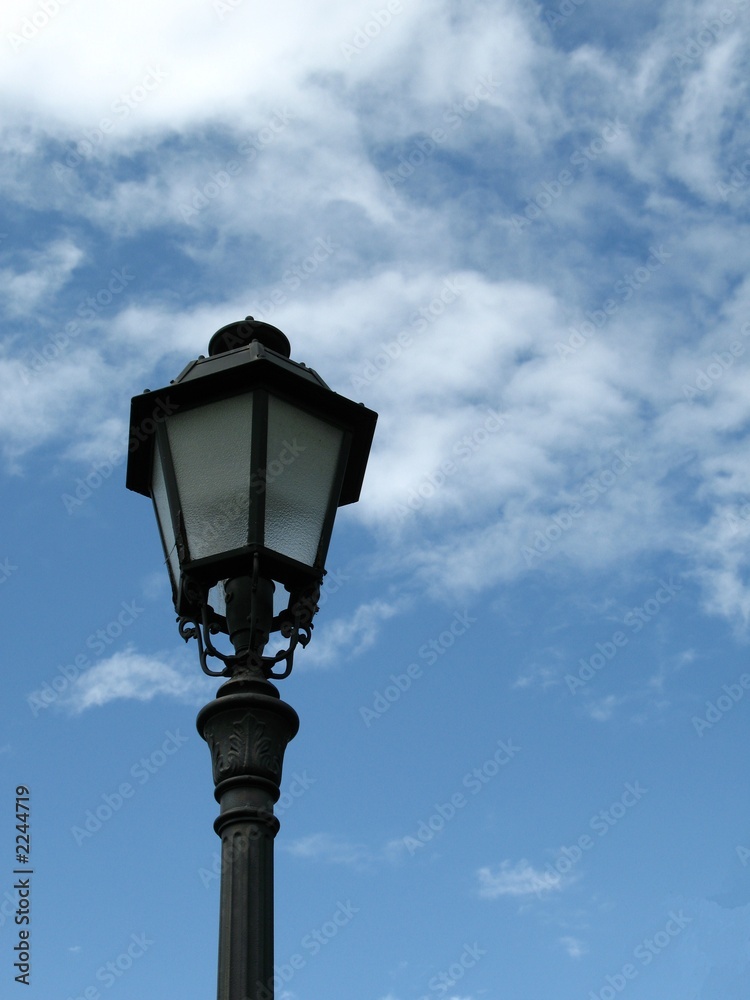 single lamp post against blue sky