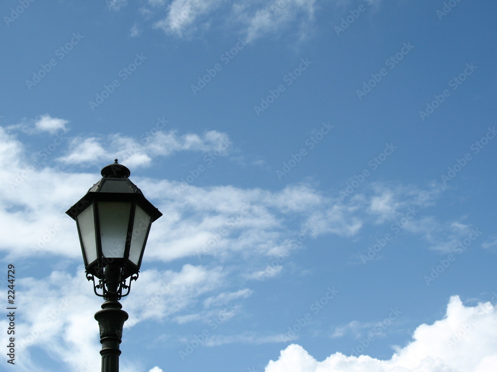 single lamp post against blue sky