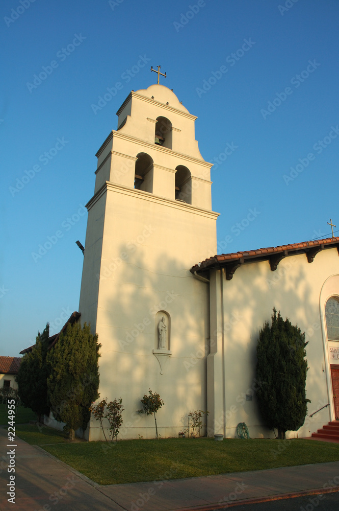 catholic church with cross on top of bell tower
