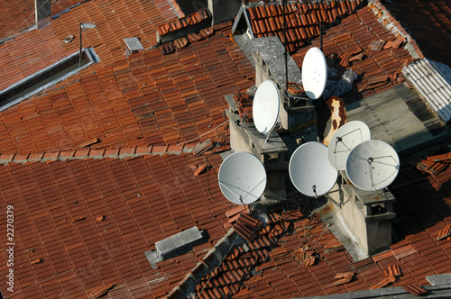 dish antennas on the tiled rooftop