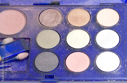 close up brush and eye shadow on a white backgroun
