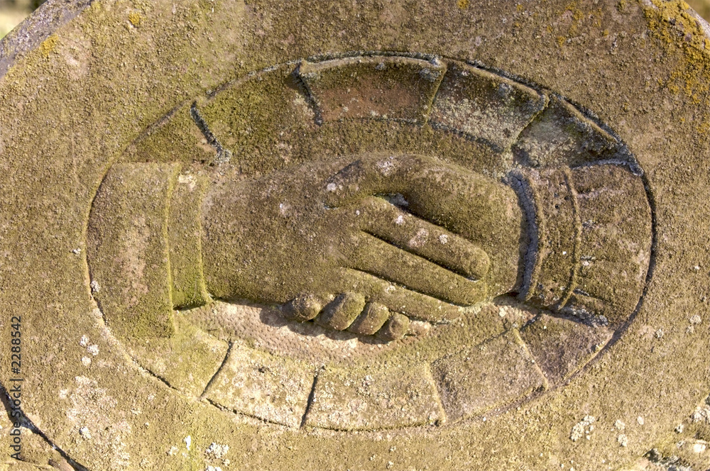 handshake on gravestone